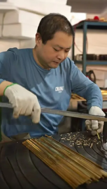 Craftsman shaping solid brass lantern frame